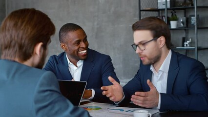 Wall Mural - Handshake of two businessmen in a modern office building