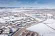Aerial view of Denver suburbs with landscape covered by snow