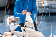 Midsection Of A Yachtsman Checking Sail Before Competition