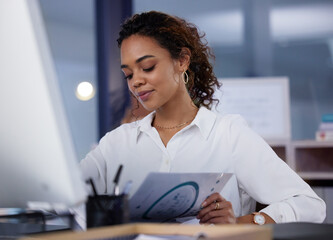 Poster - Shes got reports to compile. Shot of a young businesswoman going through paperwork in an office at work.