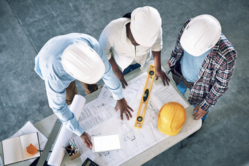 Leinwandbilder - Taking clients designs to the next level. Shot of a group of builders having a meeting at a construction site.