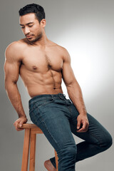 Poster - Sexy looks good on me. Shot of a handsome young man sitting on a stool in the studio and posing shirtless.