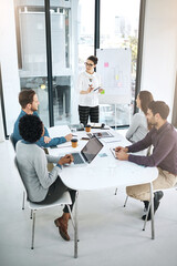Poster - Teamwork is about realising everyones potential. Shot of a businesswoman giving a presentation to her colleagues in a modern office.