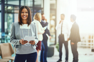 Poster - Another chance at success. Portrait of a young businesswoman using a digital tablet in an office.