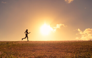 Wall Mural - Female silhouette running early morning 