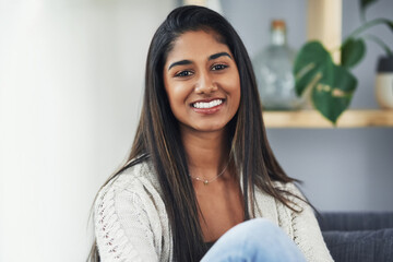 shes loving her weekend alone. cropped portrait of an attractive young woman relaxing on the couch a
