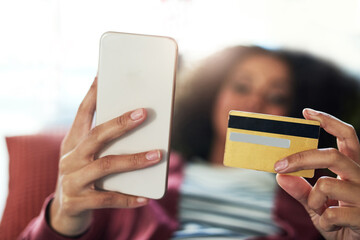 Poster - No cash, no problem. Shot of a young woman using a mobile phone and credit card on the sofa at home.