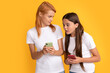 © Olena - emotional mom and child girl chatting online using modern smartphone, application
