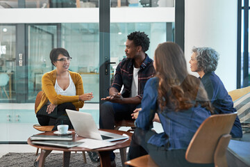 Poster - Start with an idea and go from there. Shot of a team of creative businesspeople brainstorming around a laptop in the office.