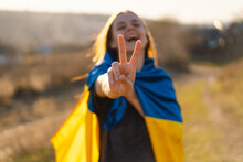 Cheerful Ukrainian Girl That Shows A Sign Of Peace Or Victory. Independence Day. Flag Day. Constitution Day.