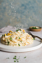 A Small Plate Of Smoked Haddock Risotto With A Sprinke Of Parmesan Falling Down