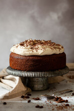 An Uncut Irish Coffee Cake Topped With Whipped Cream And Grated Chocolate.