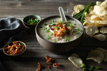 Steamy Bowl Of Chicken Jook In A Rustic Kitchen