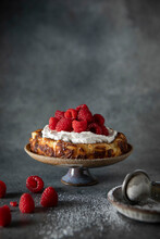 Basque Cheesecake With Whipped Cream And Raspberries