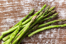  Green Asparagus On A Wooden Background.