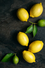 Lemons And Limes On A Textured Background.