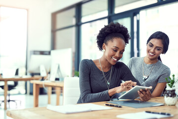 Canvas Print - Two heads are better than one. Cropped shot of two young women working in the office.