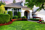 Fototapeta Tulipany - Beautiful home exterior in evening with healthy green lawn and flowerbeds