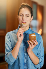 Sticker - Savouring a spoonful of joy. Cropped shot of a young woman eating peanut butter out of the jar with a spoon.