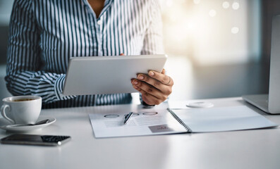 Canvas Print - The internet opens many avenues for great opportunities. Closeup shot of an unrecognizable businesswoman working on a digital tablet in an office.