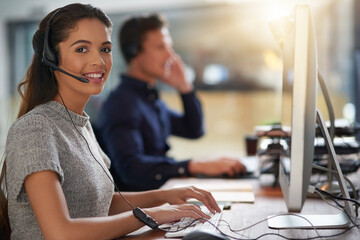 Aufkleber - Shes all about attending to customers needs. Shot of young agents working in a call center.