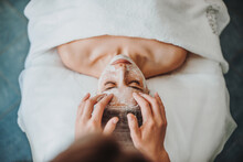 Woman Getting Facial Care By Beautician's Hands At Spa Salon. Beautiful Girl. Beauty Face. Natural Beauty. Cosmetology Beauty Procedure. Facial Skin Treatment