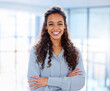 © Azee J/peopleimages.com - Personal success leads to business success. Cropped portrait of an attractive young businesswoman standing with her arms folded in the office.