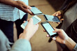 © K Seisa/peopleimages.com - Working wirelessly. High angle shot of a group of unrecognizable university students using their cellphones while standing in a campus corridor.