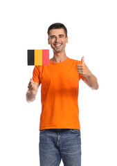 Wall Mural - Young man with flag of Belgium showing thumb-up on white background