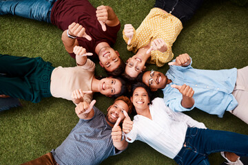 Poster - We hope lots of good comes your way. Portrait of a group of young creatives showing thumbs up while lying down in a huddle together.