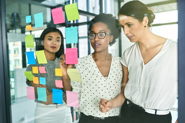 Poster - Coming up with a plan for success. Cropped shot of three businesswoman strategising in their office.