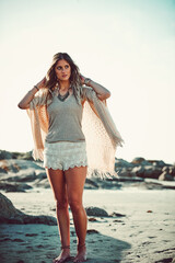 Wall Mural - Where being free is all that matters. Shot of an attractive young woman spending a day at the beach.