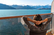 © Maridav - Tourist on cruise ship travel in Alaska relaxing looking at glaciers in Glacier Bay National Park, USA. Woman cruising Inside Passage enjoying stateroom balcony view of amazing nature landscape