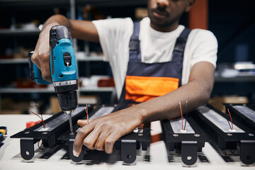 Wall Mural - factory worker using electric screwdriver