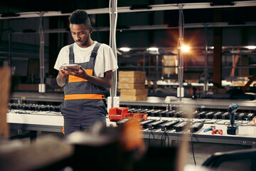 Wall Mural - african factory worker using tablet