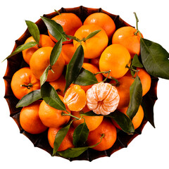 Wall Mural - Fresh mandarin oranges fruit or tangerines with leaves in wooden box, top view