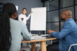 © Chanelle M/peopleimages.com - We have to cover all our bases. Shot of a young businesswoman using a whiteboard during a presentation to her colleagues in an office.