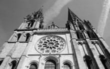 Cathedral Of Chartres And The Traces Of The Planes In The Sky. Chartres, France. Black White Historic Photo.