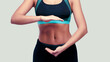 © khmelev - Sporty fitness smiling woman show her strong abs on isolated background. Cropped image