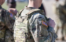 Detail View Of The US Army Uniform Worn By Soldiers In A Military Base. Flag Of America On The Uniform.