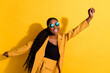 © deagreez - Portrait of attractive cheerful wavy-haired girl dancing having fun good mood rest isolated on bright yellow color background