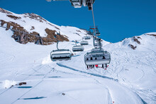 St. Anton Am Arlberg. March 10, 2022. Skiers Sit In Chairlifts On Mountain Slope At Ski Resort During Beautiful Sunny Day, Skiers Riding Skilifts During Skiing Holiday