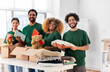© Syda Productions - charity, donation and volunteering concept - international group of happy smiling volunteers packing clothes and other stuff in boxes at distribution or refugee assistance center