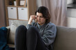 © Syda Productions - mental health, psychological problem and depression concept - sad crying woman sitting on sofa at home
