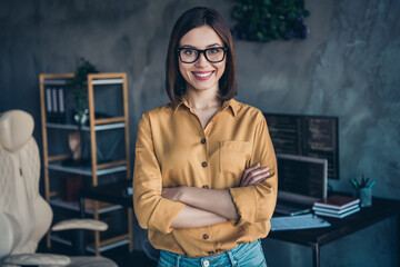 Wall Mural - Portrait of attractive skilled smart cheerful girl folded arms developing web project at workplace workstation indoors