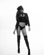 © MASTER111111 - Girl in black leather jacket and boots. High fashion portrait of a beautiful young elegant woman.Black and white studio shot, soft gray background. Full length portrait