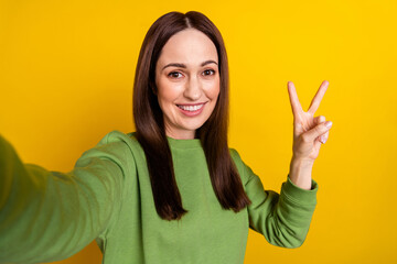 Canvas Print - Self-portrait of attractive cheerful woman good mood showing v-sign isolated over bright yellow color background