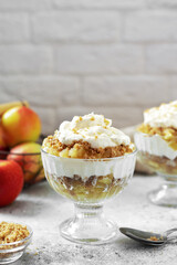 Wall Mural - Apple trifle in a glass bowl on a light culinary background. Traditional Scandinavian aebletrifli on the kitchen table