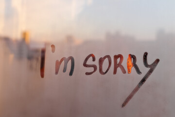 Wall Mural - Lettering text I am sorry on foggy glass of sunset window