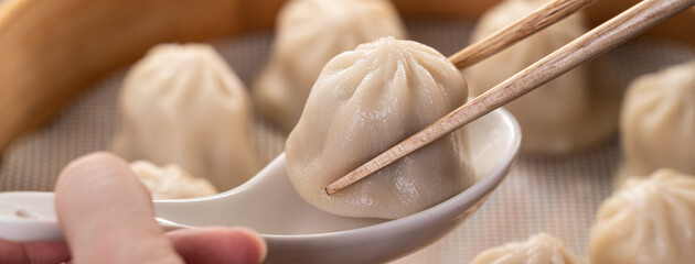 Wall Mural - Steamed pork soup dumplings named Xiao long bao xiaolongbao in Taiwan.